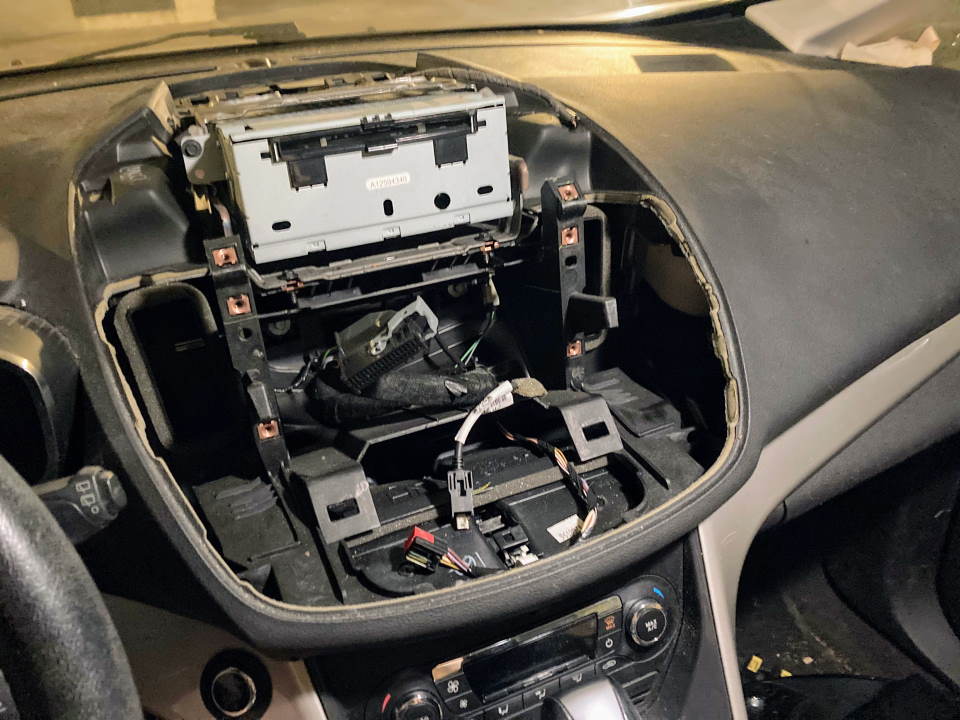 Car dashboard with top part opened up to reveal display system's guts